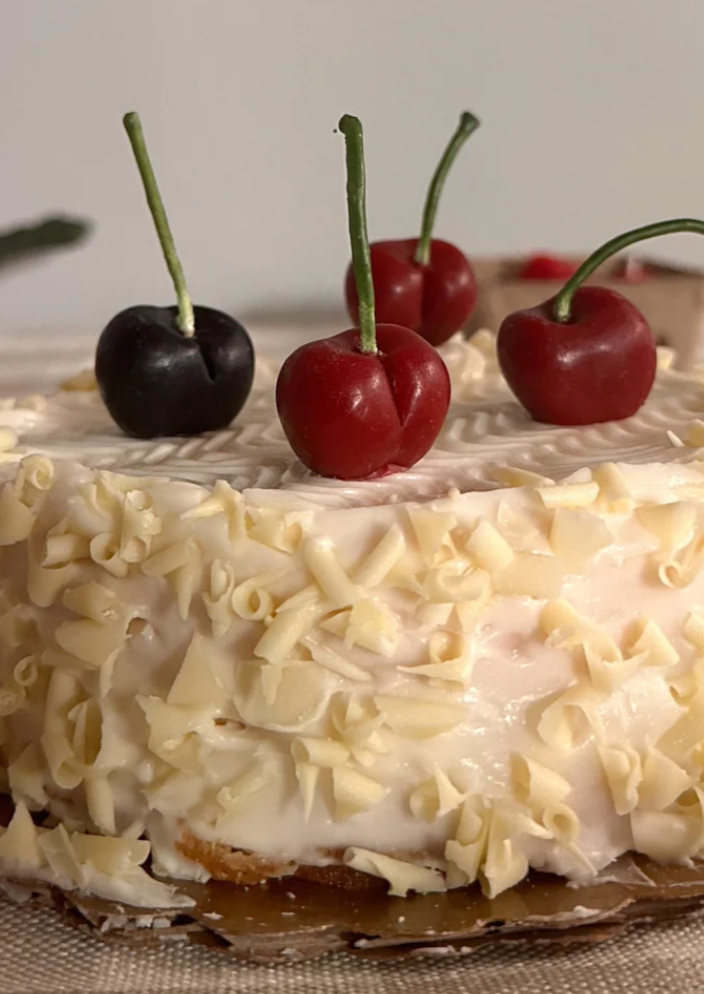 cherry candles on cake