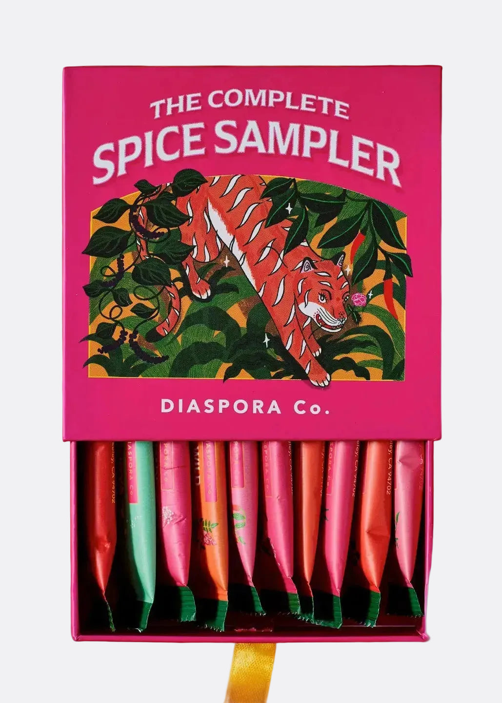 Pink spice sampler box with tiger design on an orange background