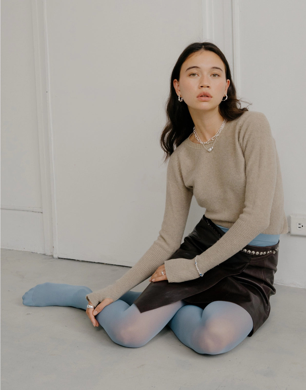 model wearing silver necklaces layered