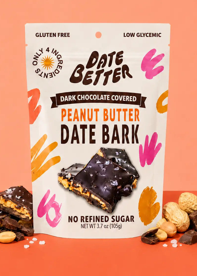 Packaging of Date Better dark chocolate covered peanut butter date bark on a peach background