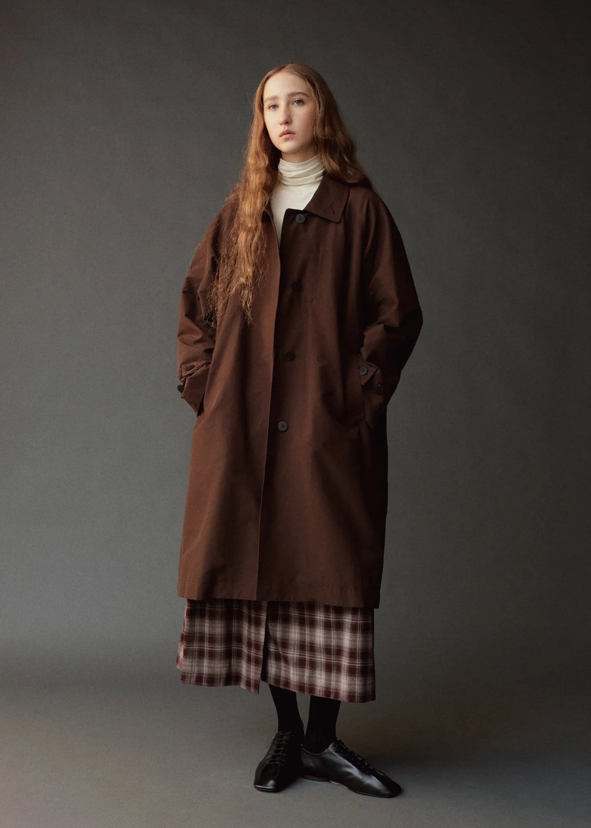 person modeling long brown trench coat