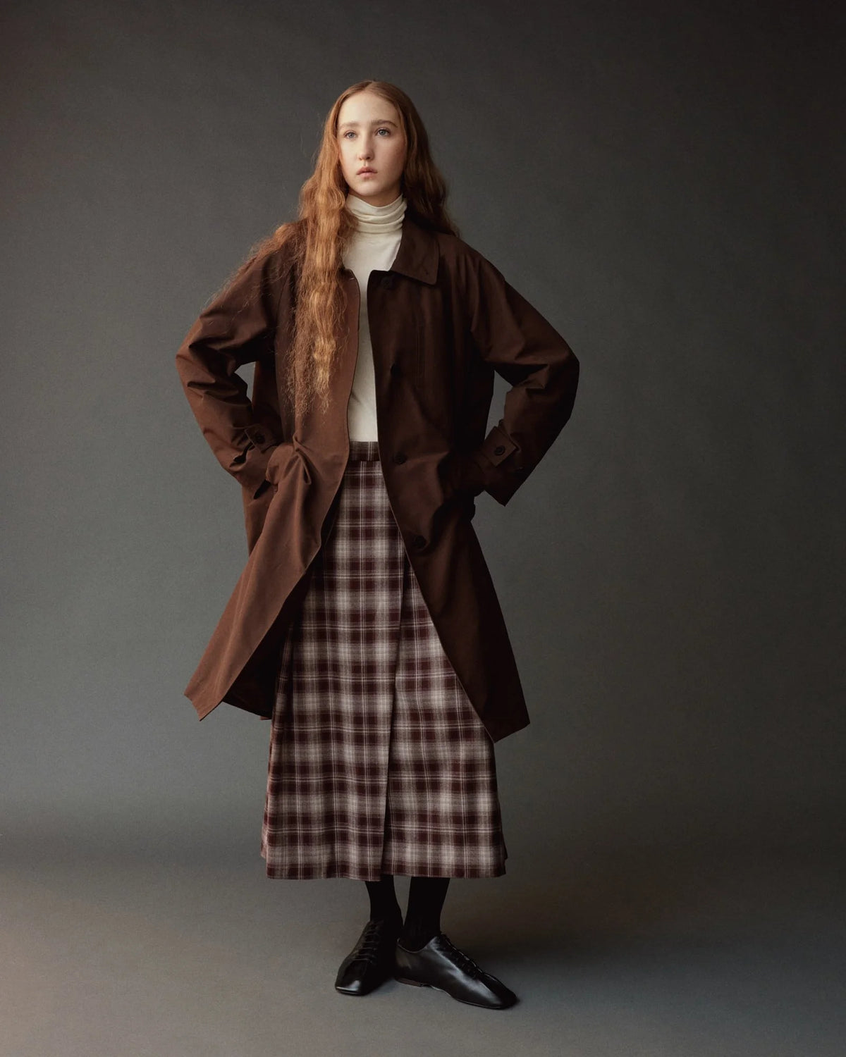 person modeling long brown trench coat