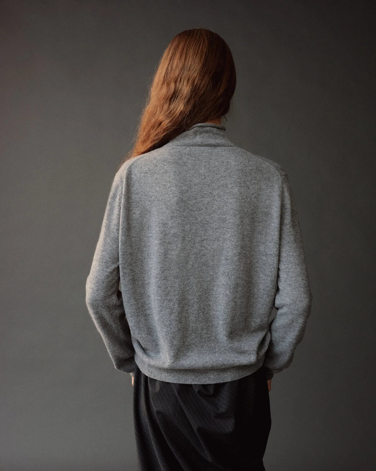 gray button down cardigan with mock neck on model from back
