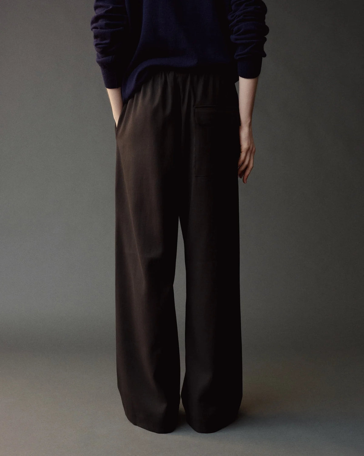 wool drawstring pants on model from back
