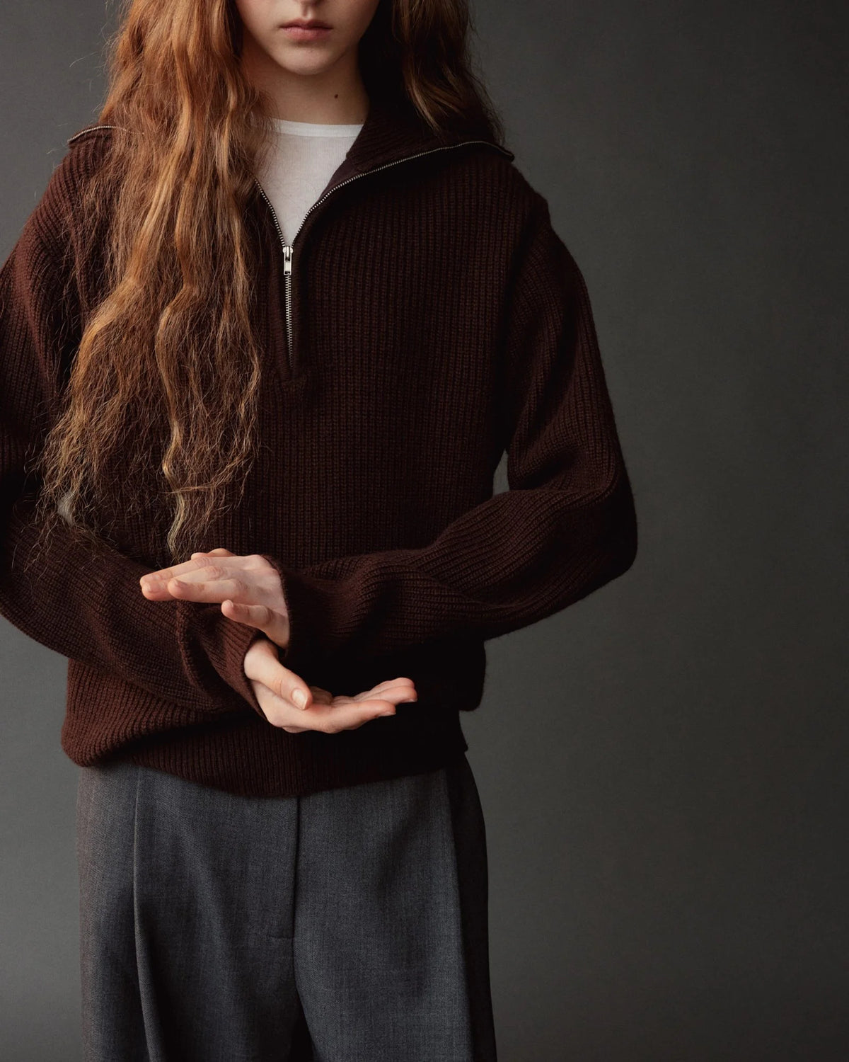 brown half zip sweater on model wearing gray pants