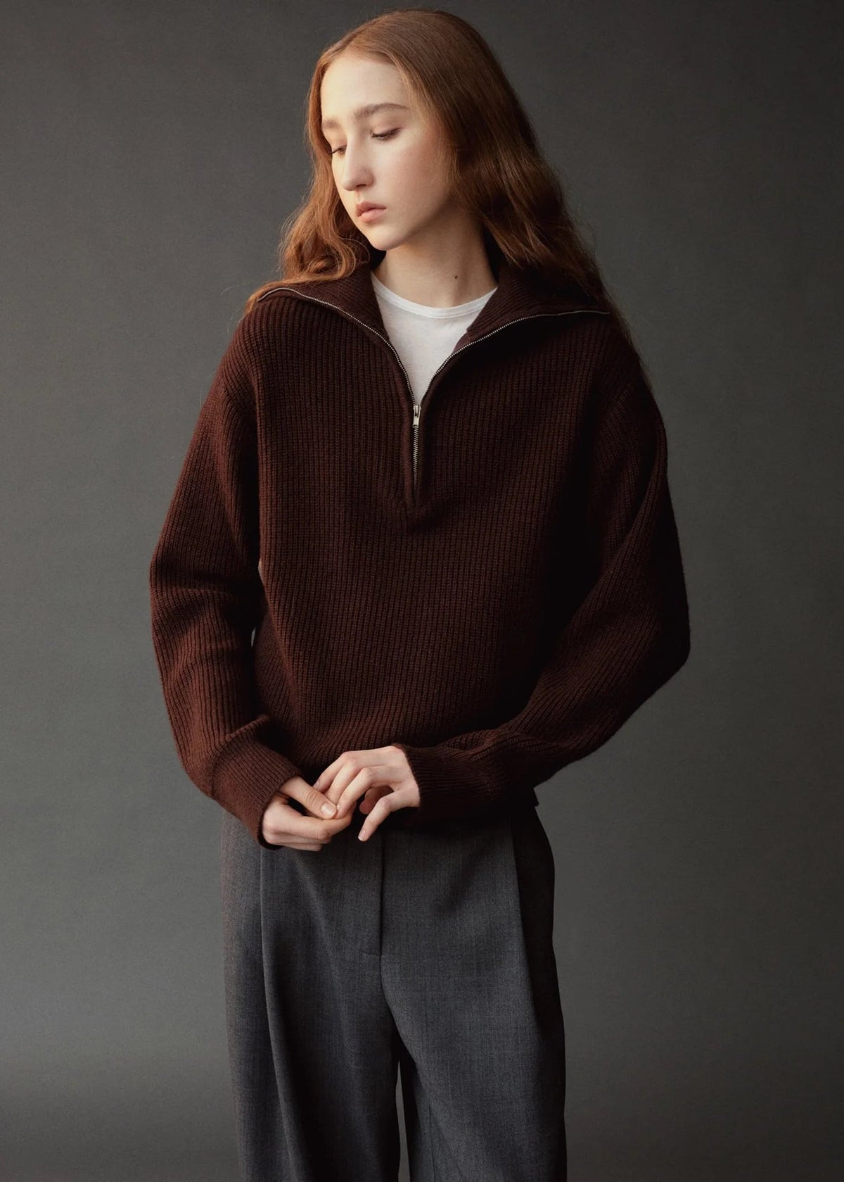 brown half zip sweater on model wearing gray pants