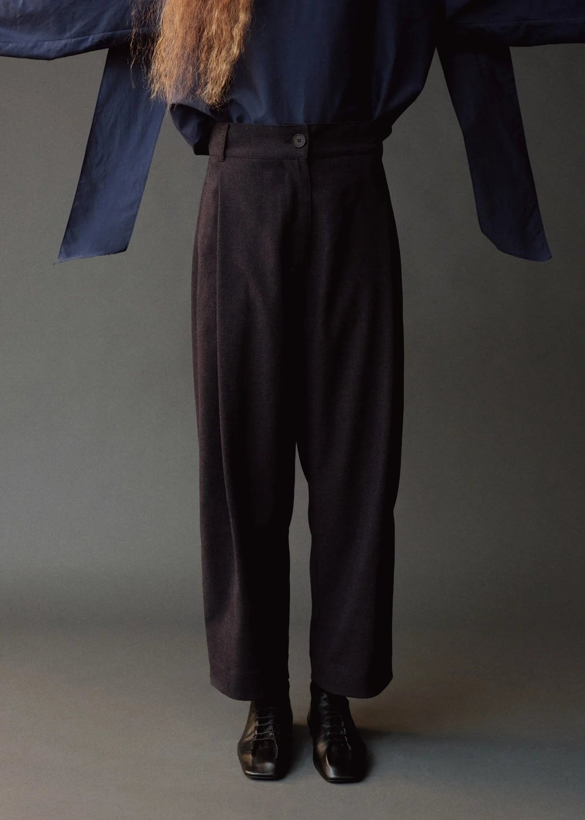 model wearing straight leg pants in dark brown