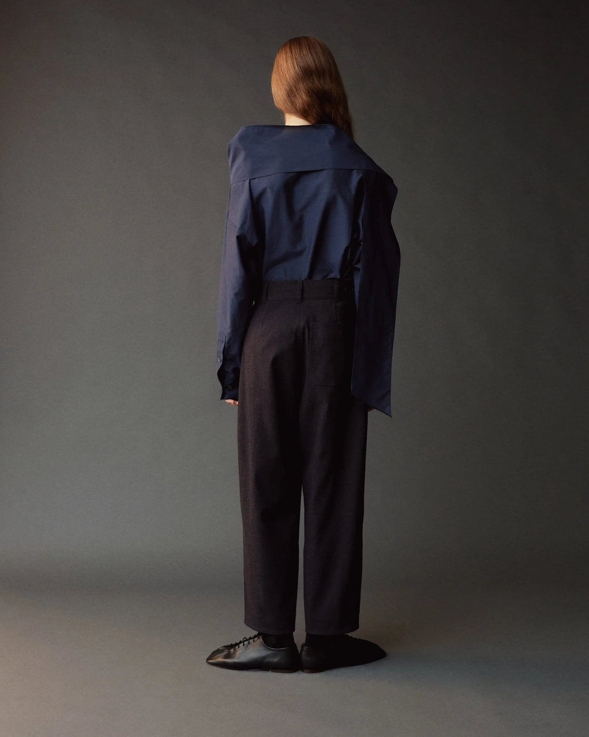 model wearing straight leg pants in dark brown from back