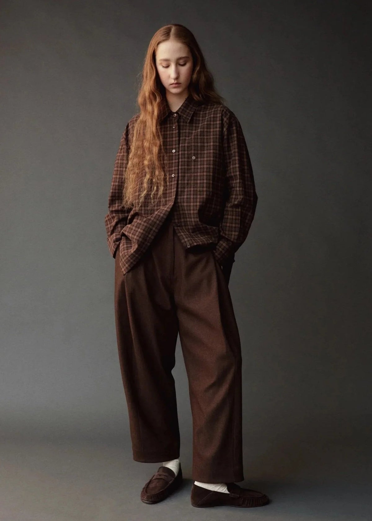 oversized brown plaid shirt on model wearing brown pants