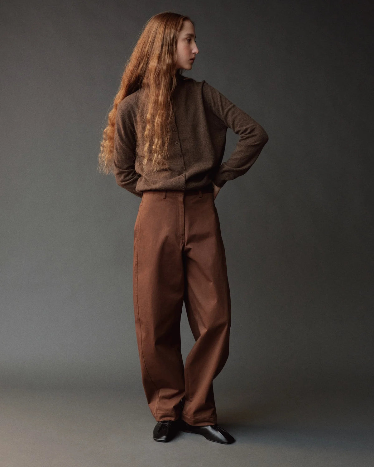 brown button down cardigan with mock neck on model wearing brown pants