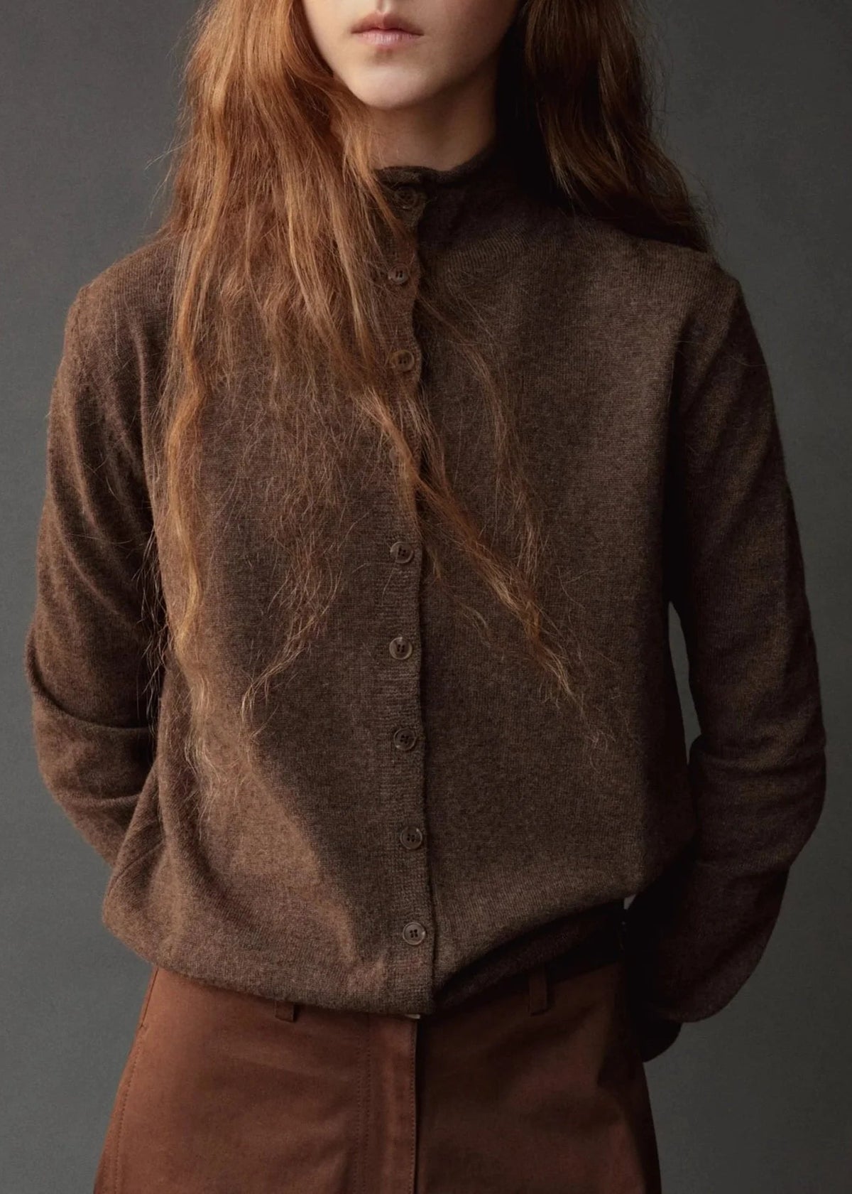 brown button down cardigan with mock neck on model wearing brown pants