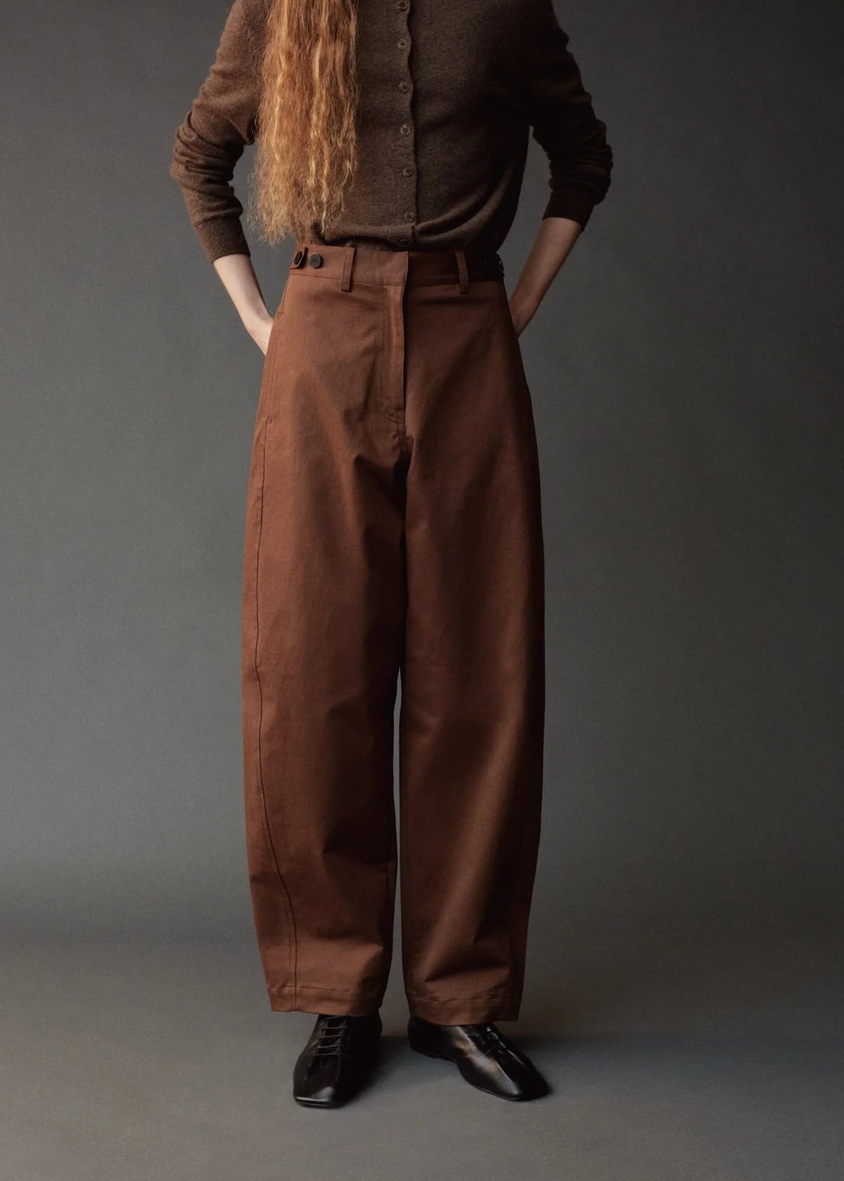 barrel leg pants in brown on model 