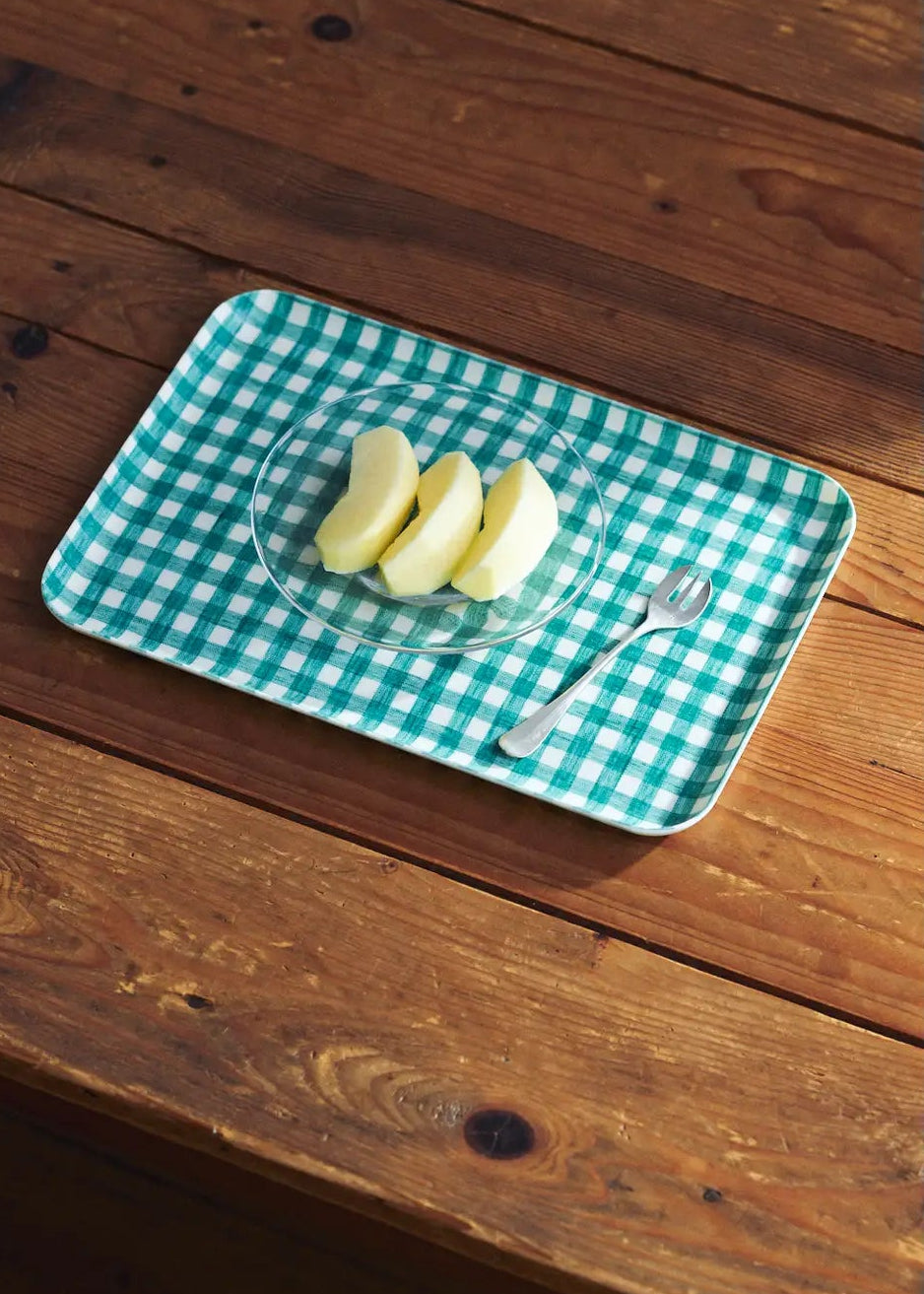 Green checkered tray on a wooden surface