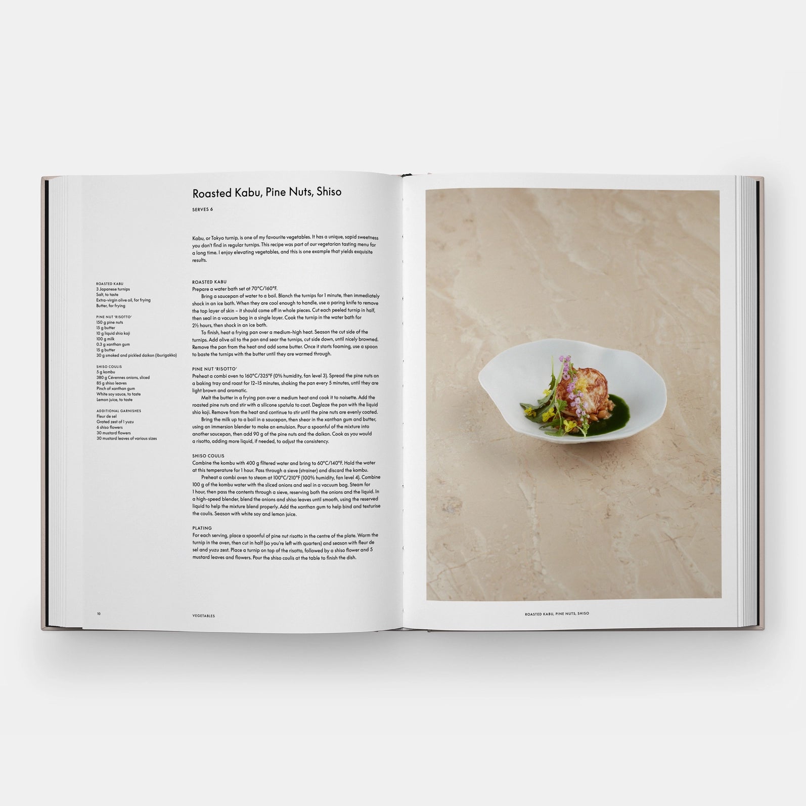 Open book showing a recipe with a photograph of a dish on a wooden surface