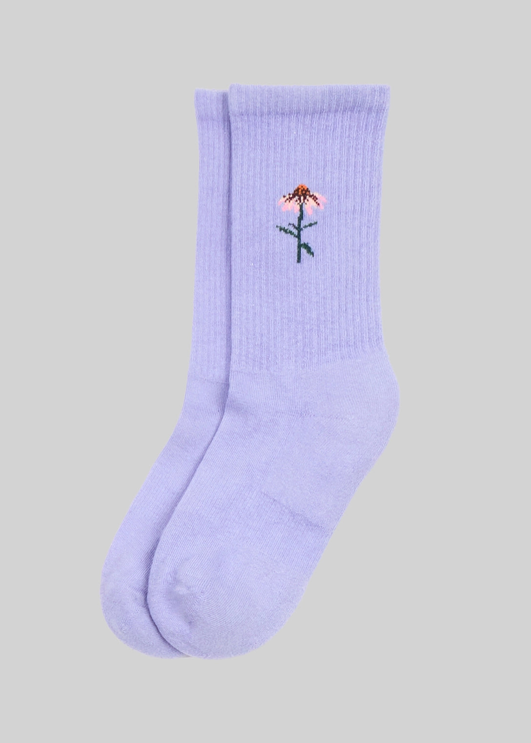 Light purple sock with a embroidered design on a gray background
