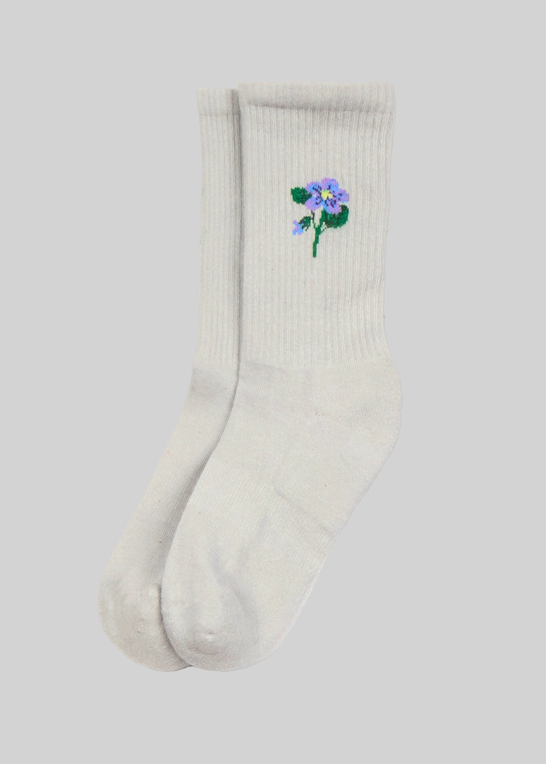 White sock with a floral design on a light gray background