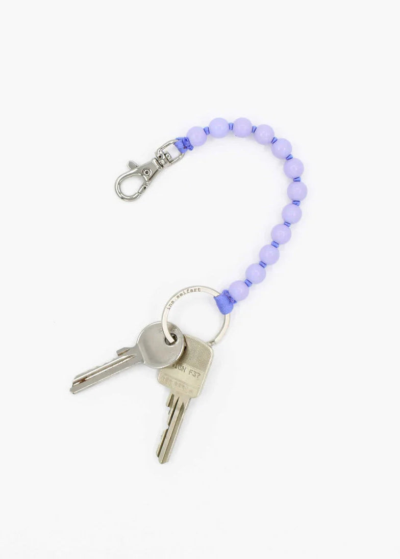Keychain with beads and keys on a white background