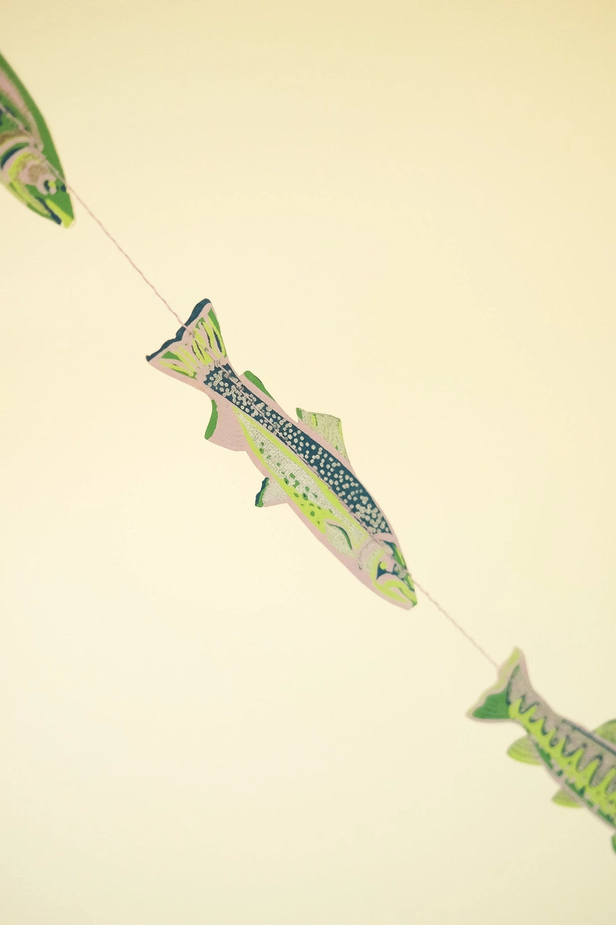 Decorative paper fish banner on a beige background
