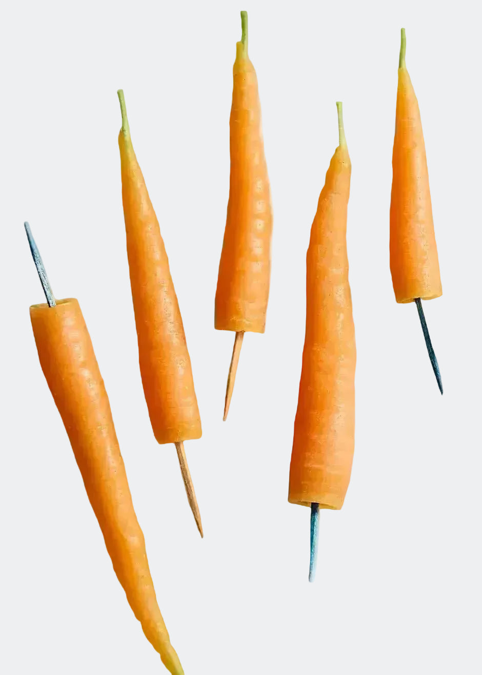 Carrots with toothpicks on a white background