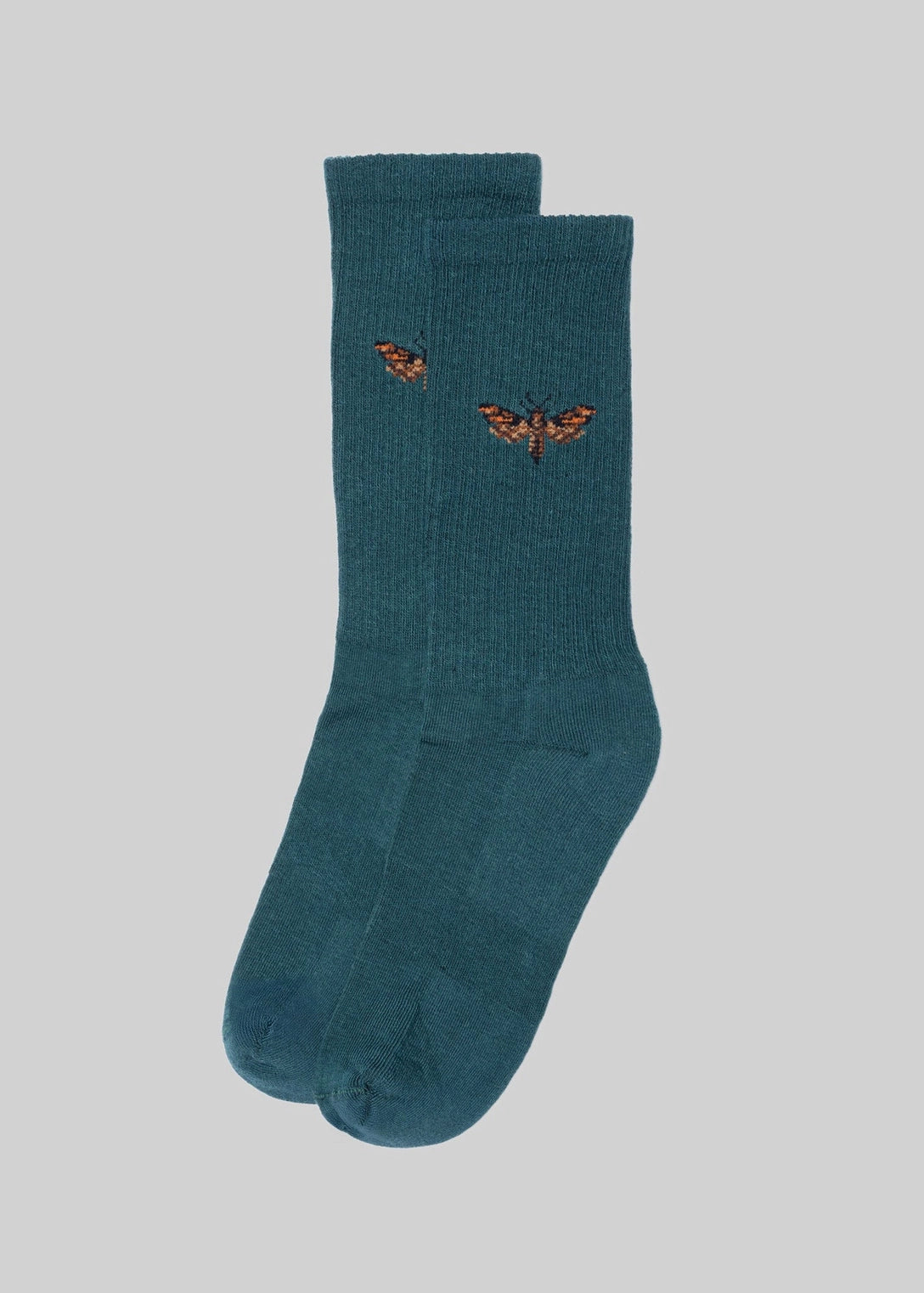 Teal socks with embroidered details on a light gray background