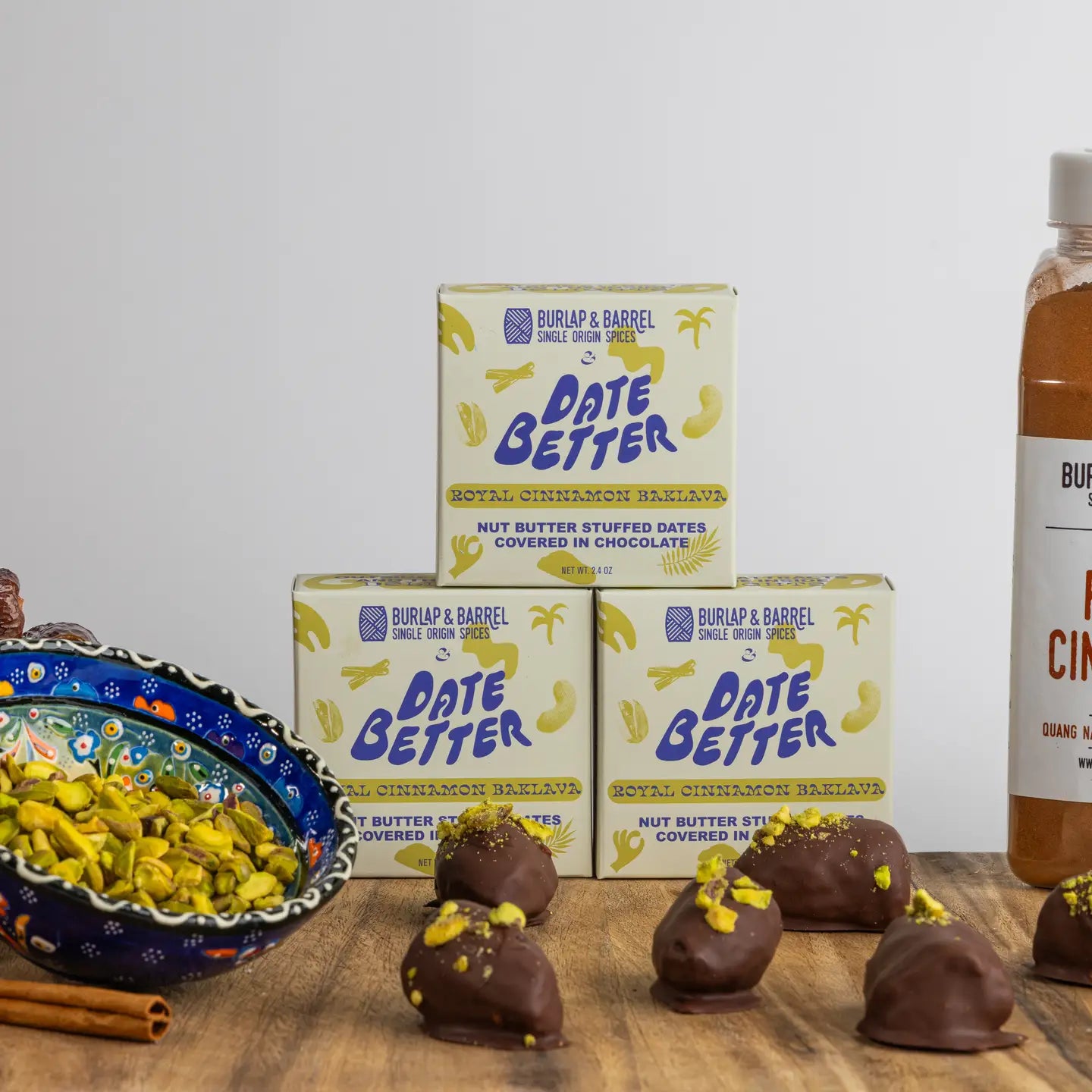Burlap & Barrel Date Better products on a wooden surface with a bowl of nuts 