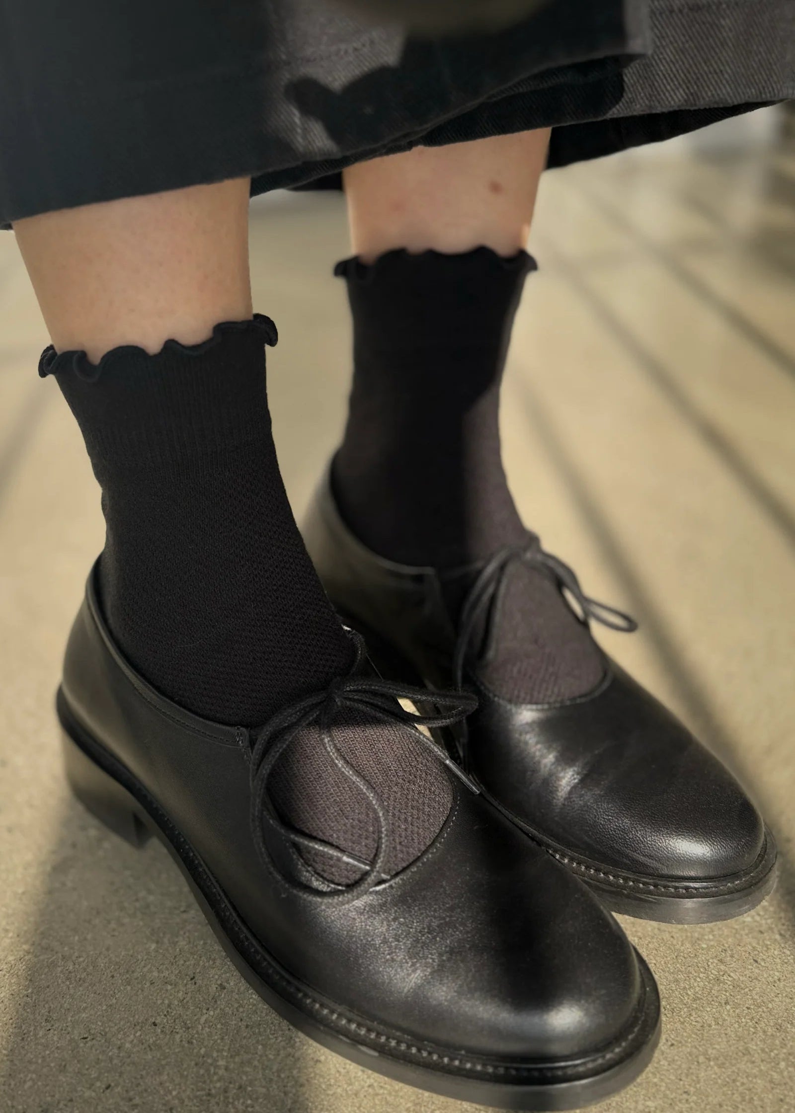 black ruffled socks on model 