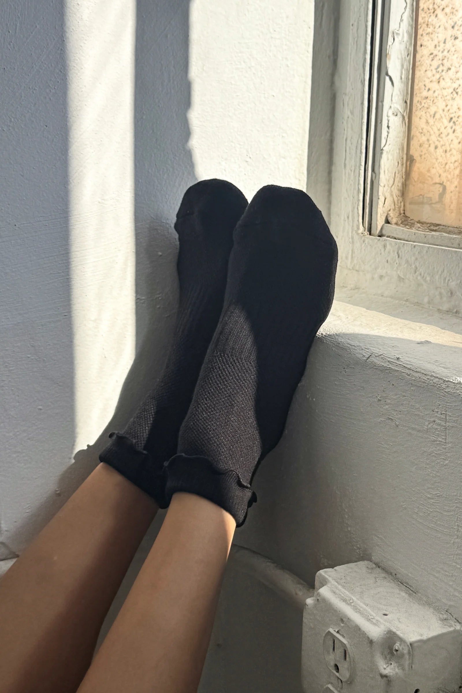 black ruffled socks on model