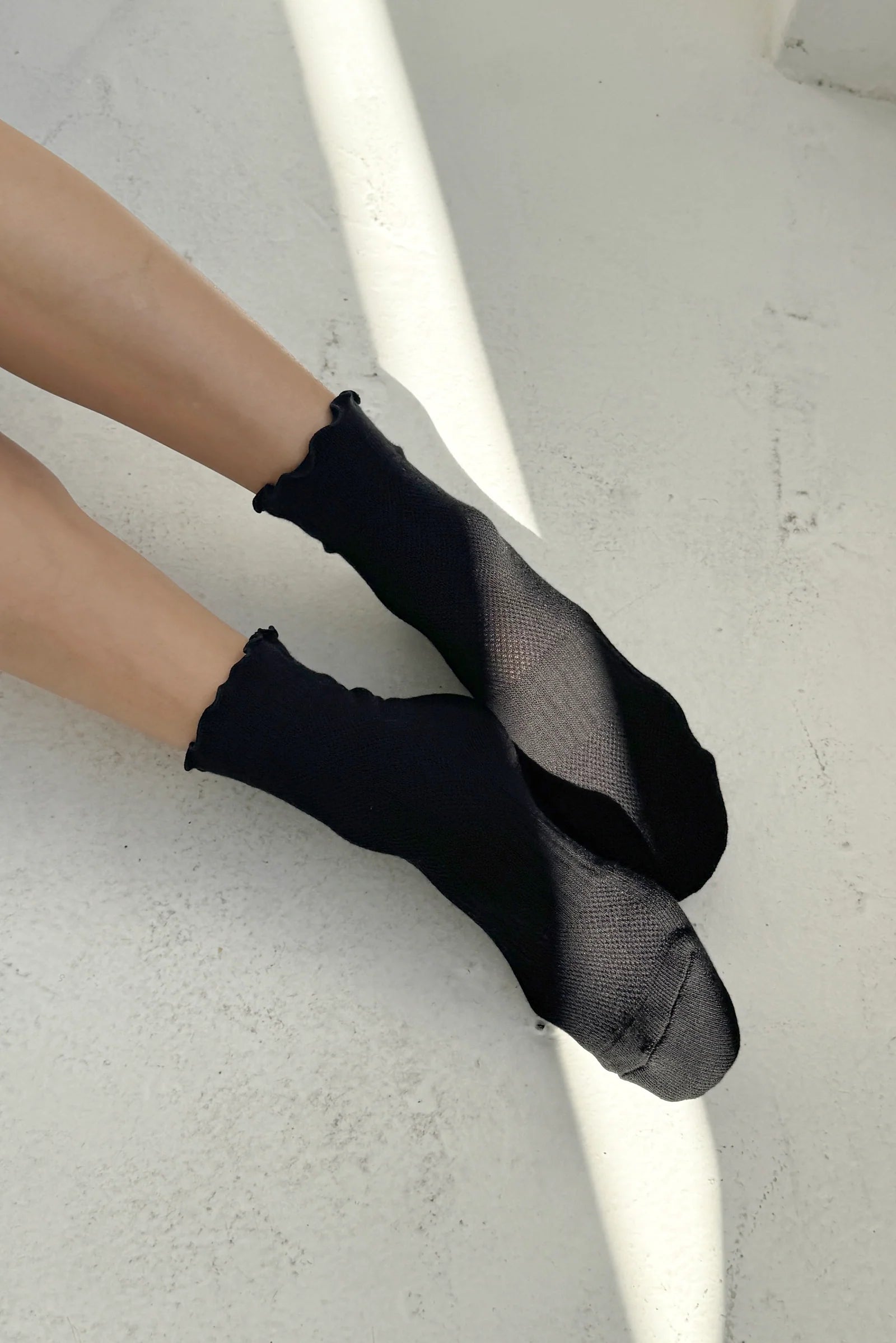 black ruffled socks on model