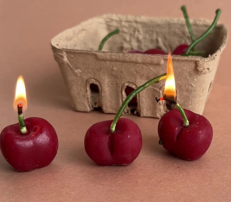 cherry shaped candles in produce box