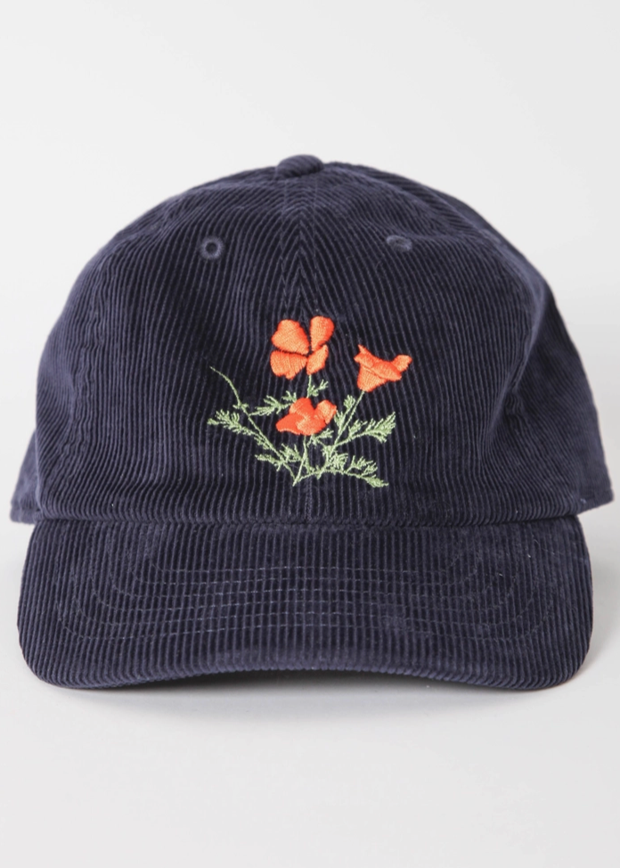 Navy blue corduroy cap with floral embroidery on a white background
