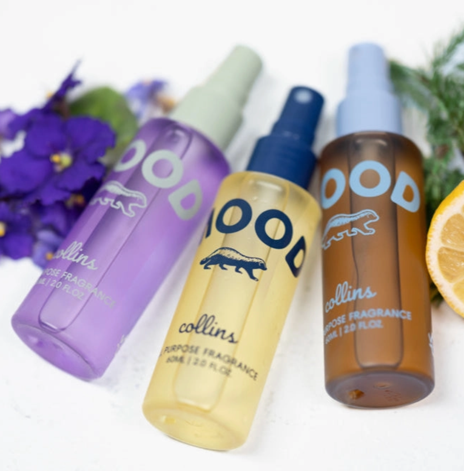 Four bottles of 'Collins' fragrance with different colored caps on a white background.