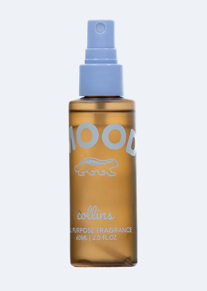 Collins Purpose Fragrance bottle with gold body and blue spray nozzle on a white background