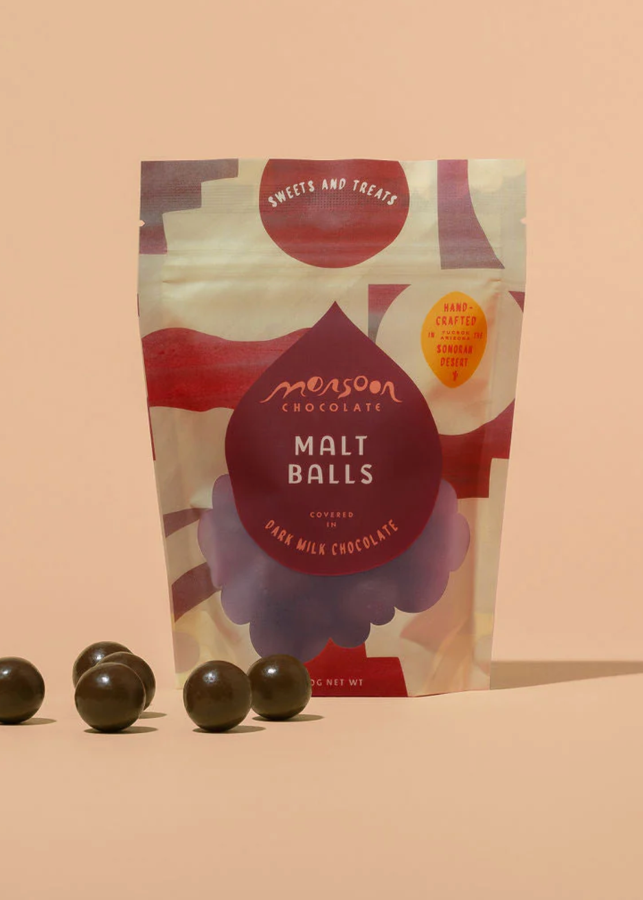 Packaging of MonsoonChocolate Malt Balls on a beige background