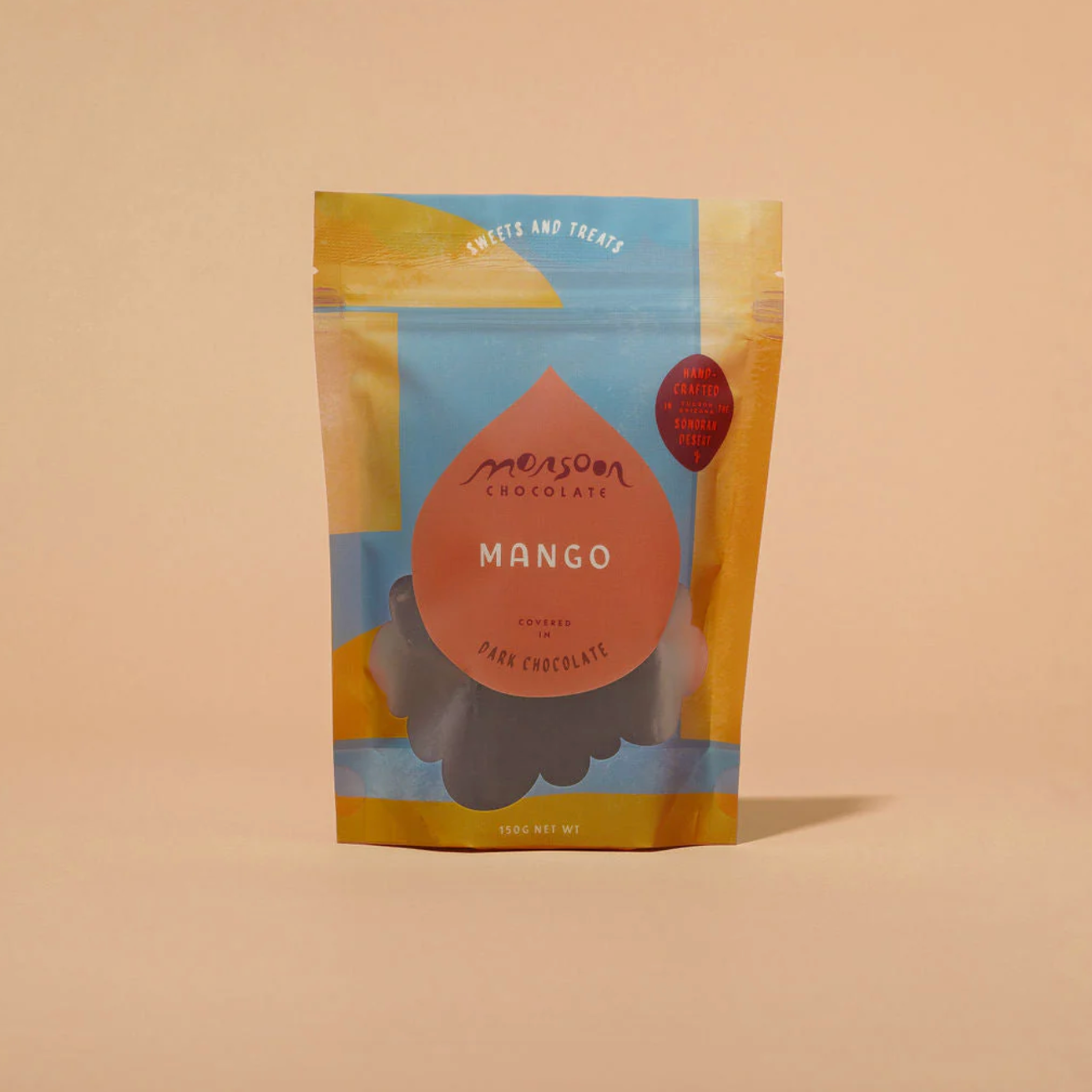 Mango dark chocolate packaging with 'Monsoon Chocolate' branding on a beige background
