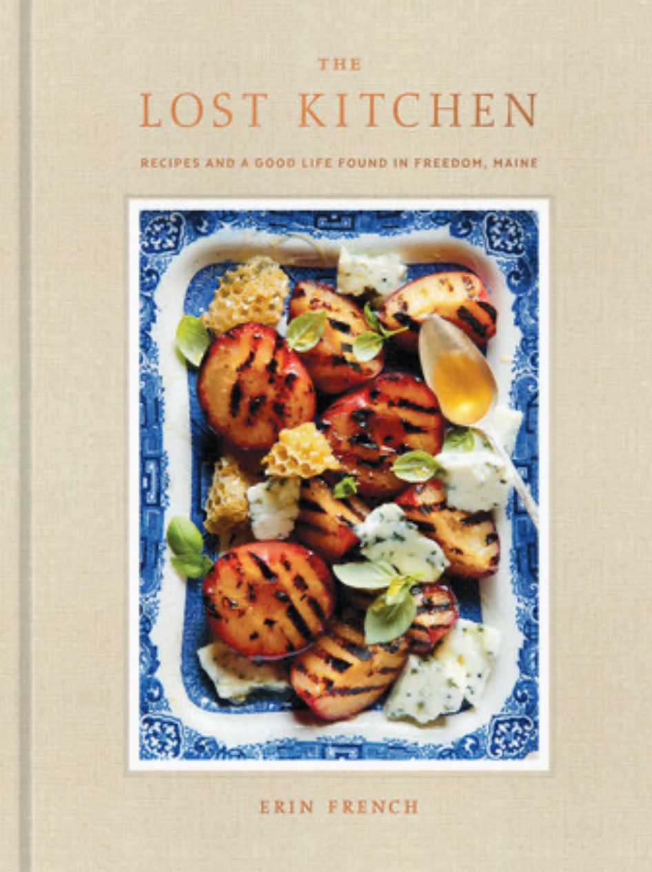 Book cover of 'The Lost Kitchen' with a dish of grilled peaches on a blue and white plate.