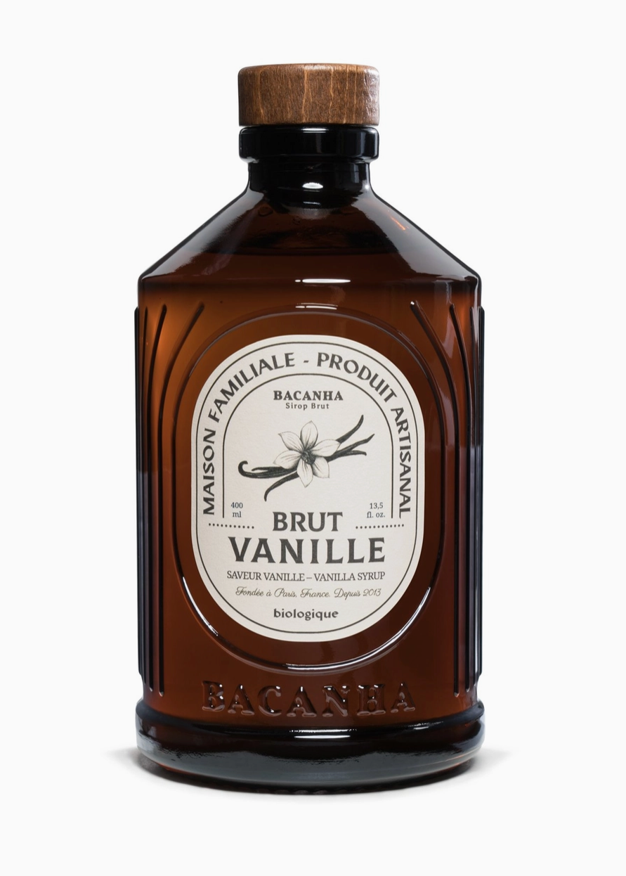 brown bottle with white label and drawing of botanical vanilla and black text