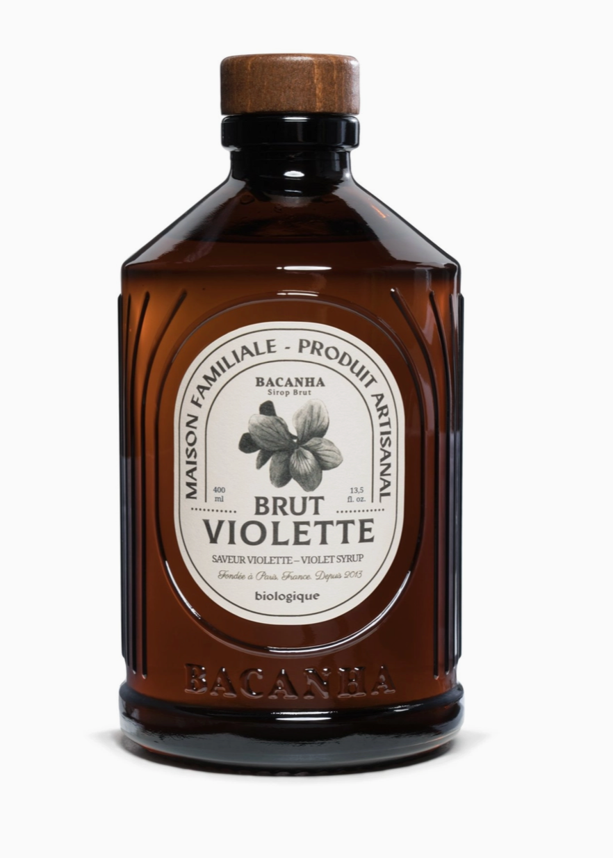 brown bottle with white label and drawing of a violet and black writing
