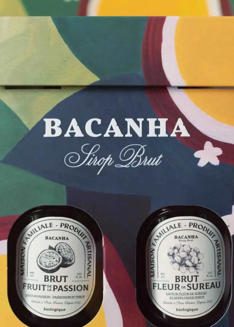 two syrups in painterly paper packaging with greens, blue, yellow and purple