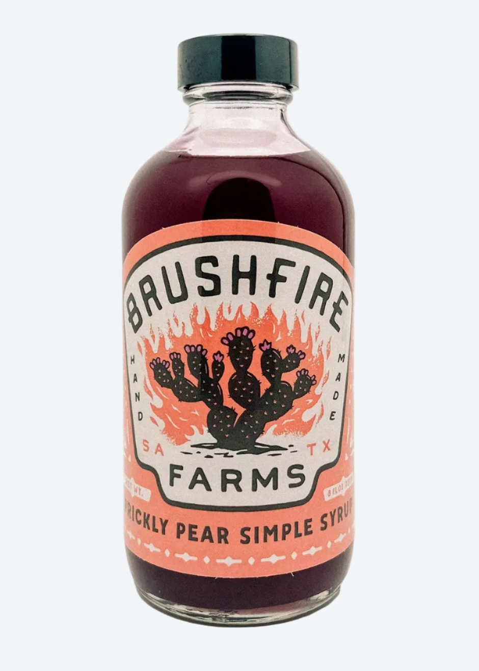 glass bottle of product with branded label "BRUSHFIRE FARMS" and cactus illustration