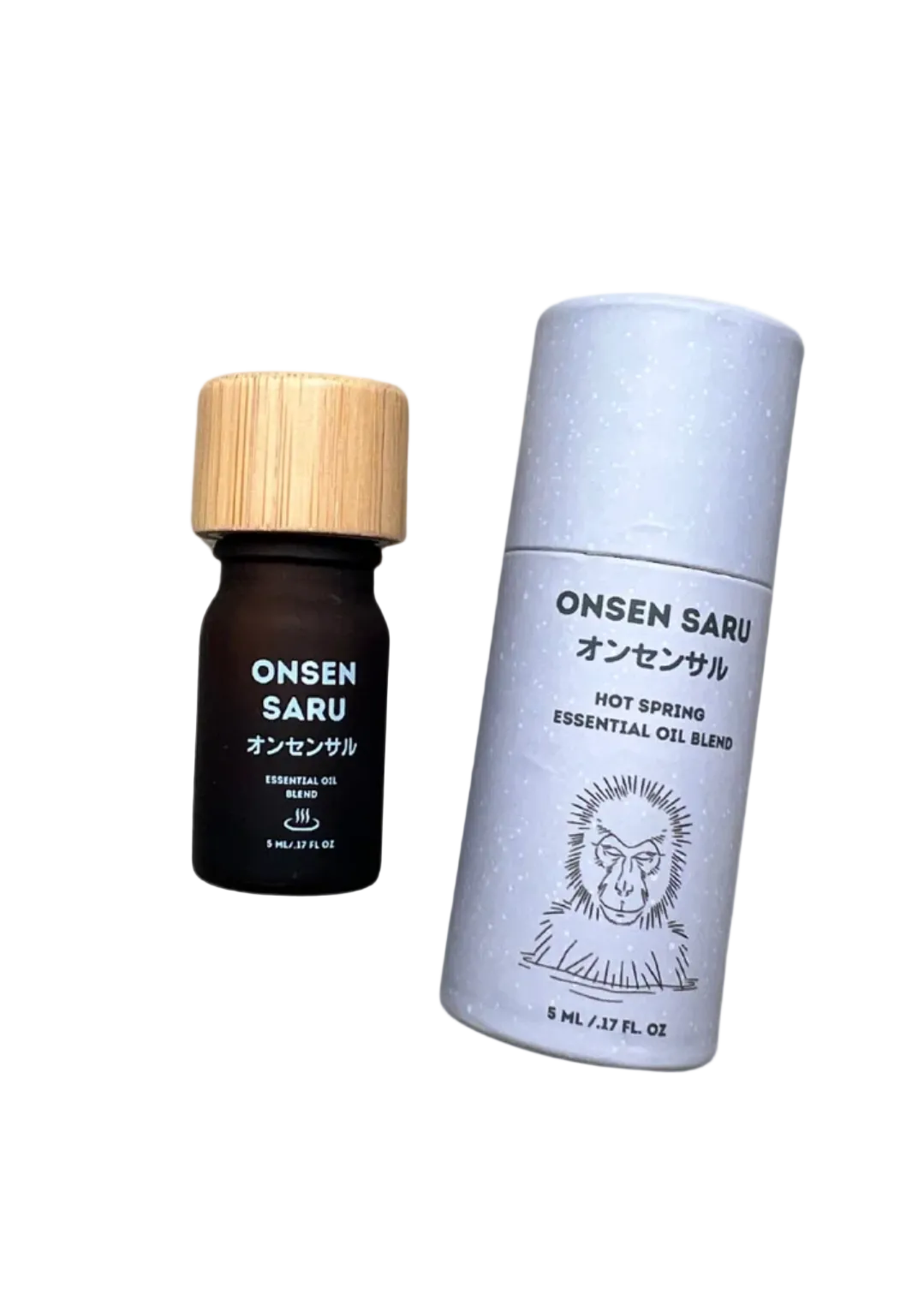 A small dark amber essential oil bottle with a light wood cap stands next to a tall white cylindrical box labeled ONSEN SARU, on a plain white background.