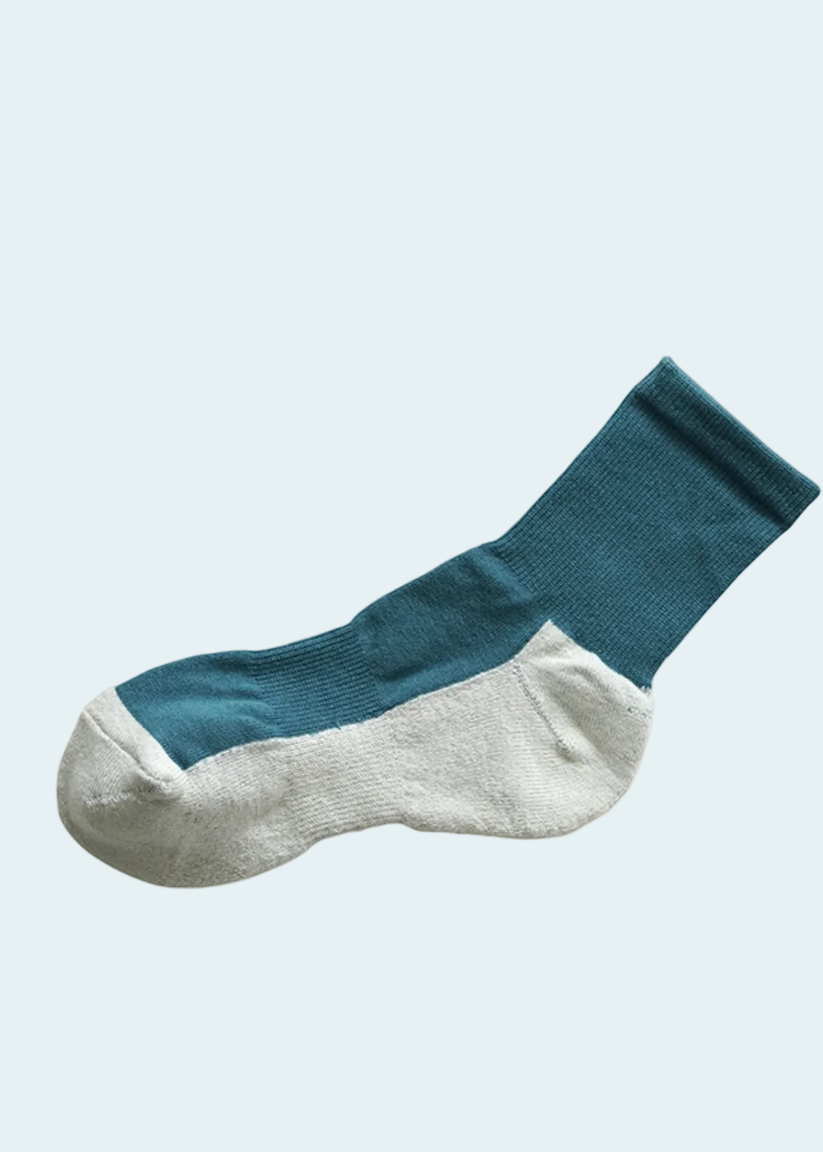 A single crew sock with a teal blue upper and a white toe and heel, shown against a plain white background.