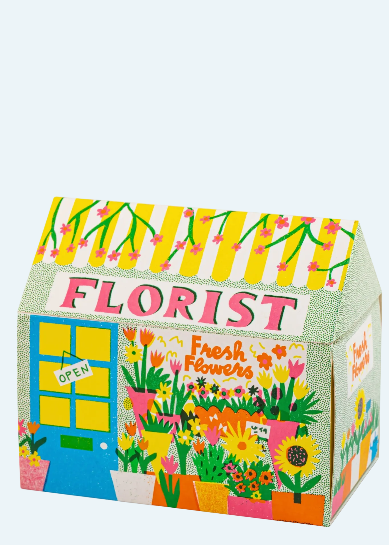 A colorful cardboard display box shaped like a flower shop, printed with 'FLORIST', 'Fresh Flowers', a blue window with an 'OPEN' sign, and floral illustrations