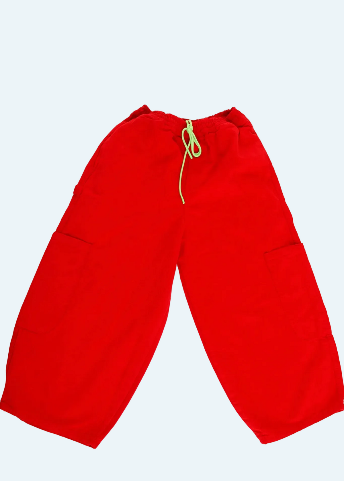 flat lay of tomato red wide leg pants with neon green drawstring