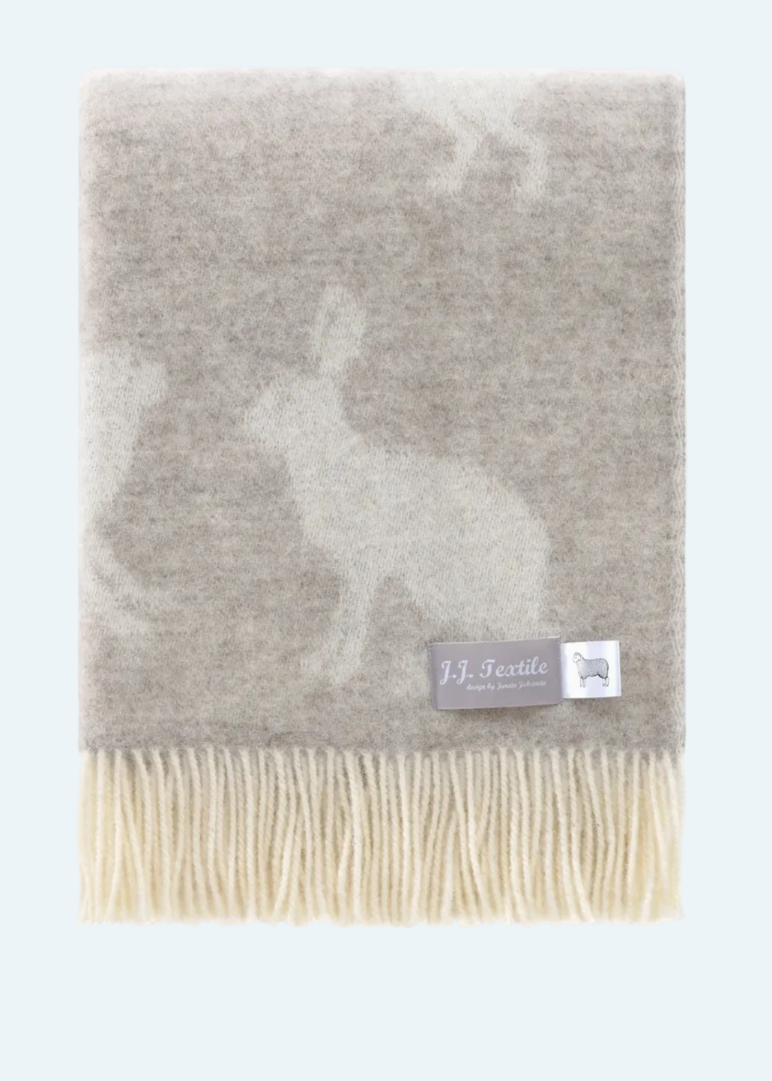 soft brown blanket with white hares and fringe