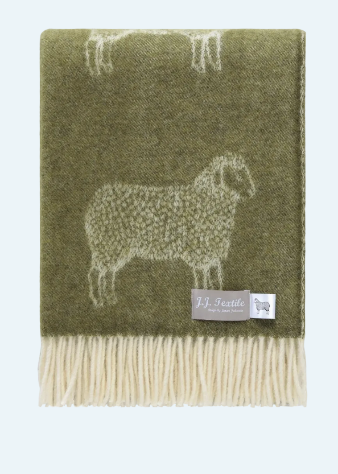 green throw with white fringe and sheep