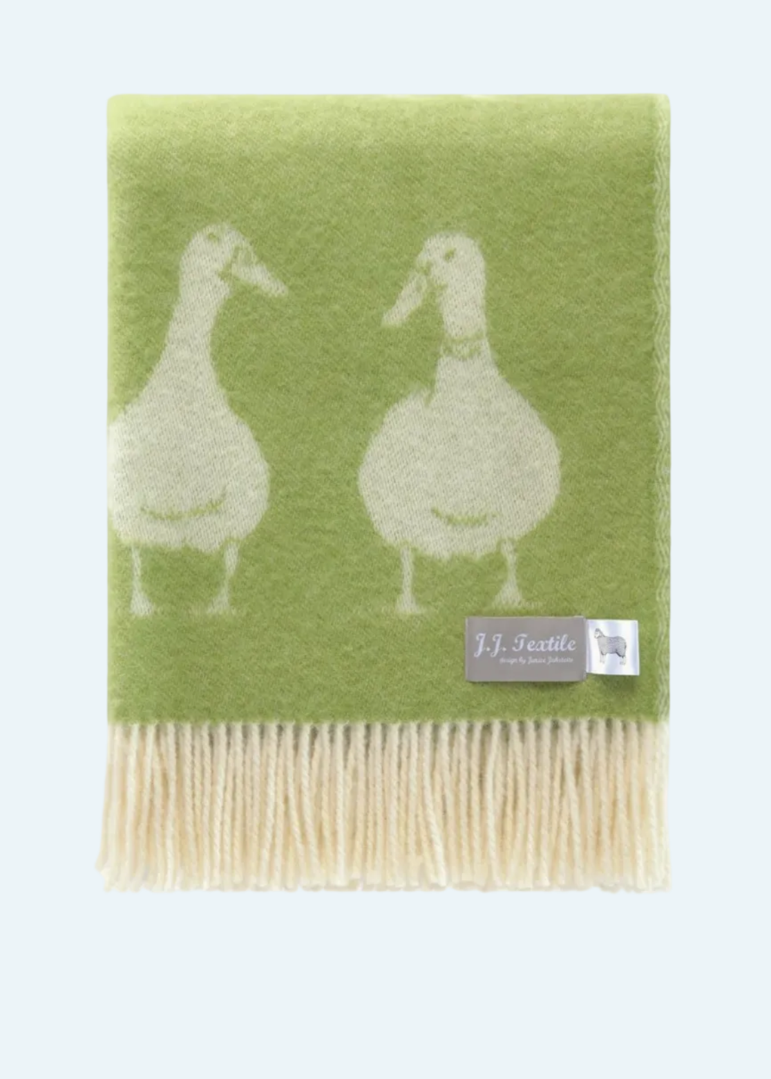 green blanket with ducks and fringe