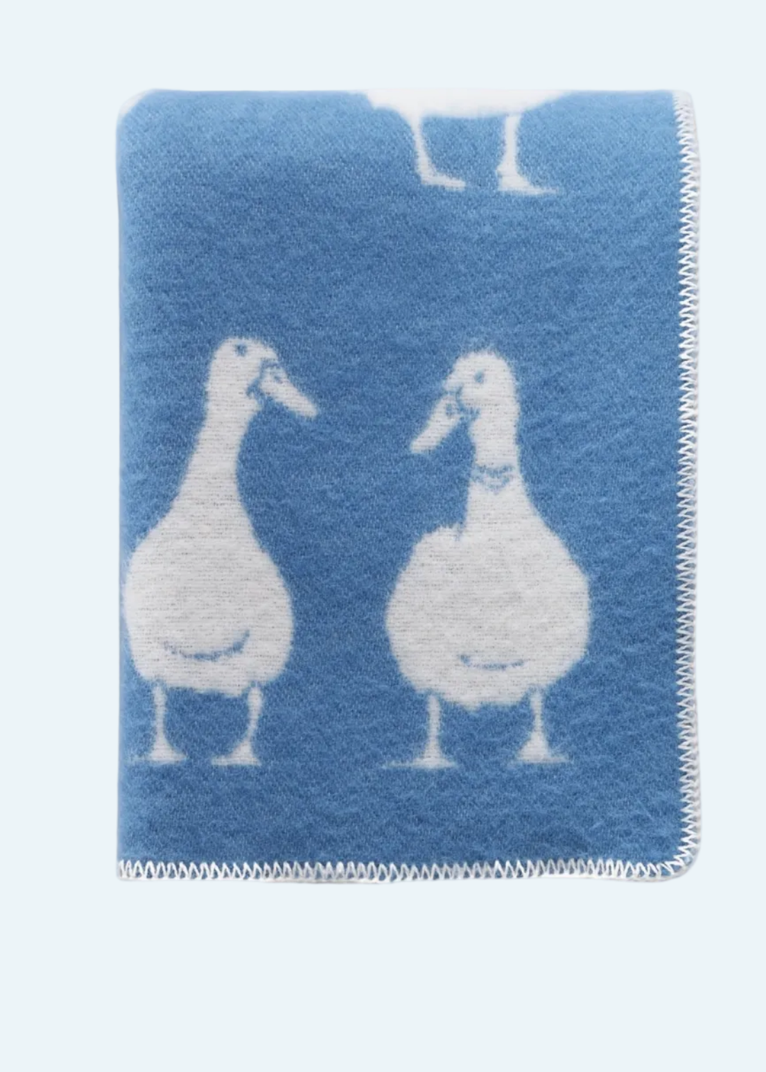 blue blanket with white ducks
