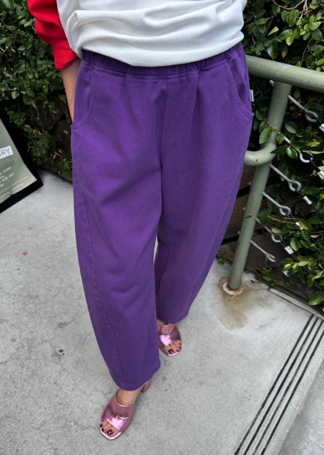 model wearing purple pants with purple high heels