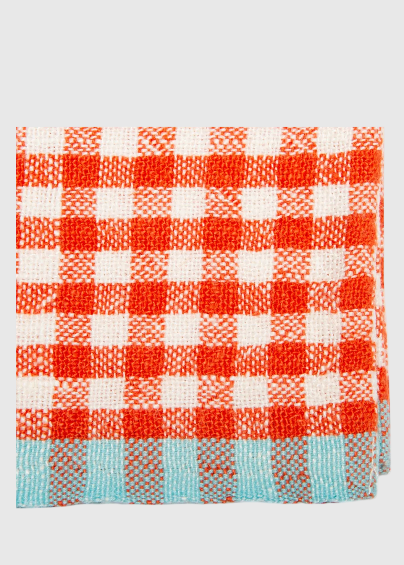 Red and white checkered towel with blue border on a light gray background