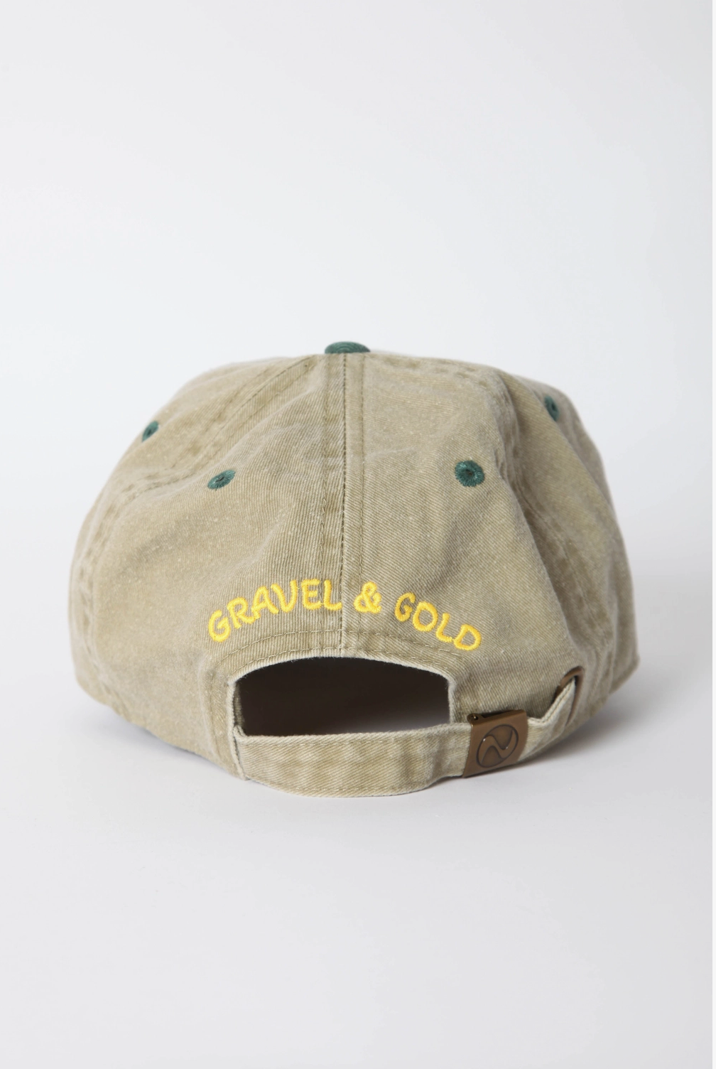 Beige cap with 'Gravel & Gold' text on a white background